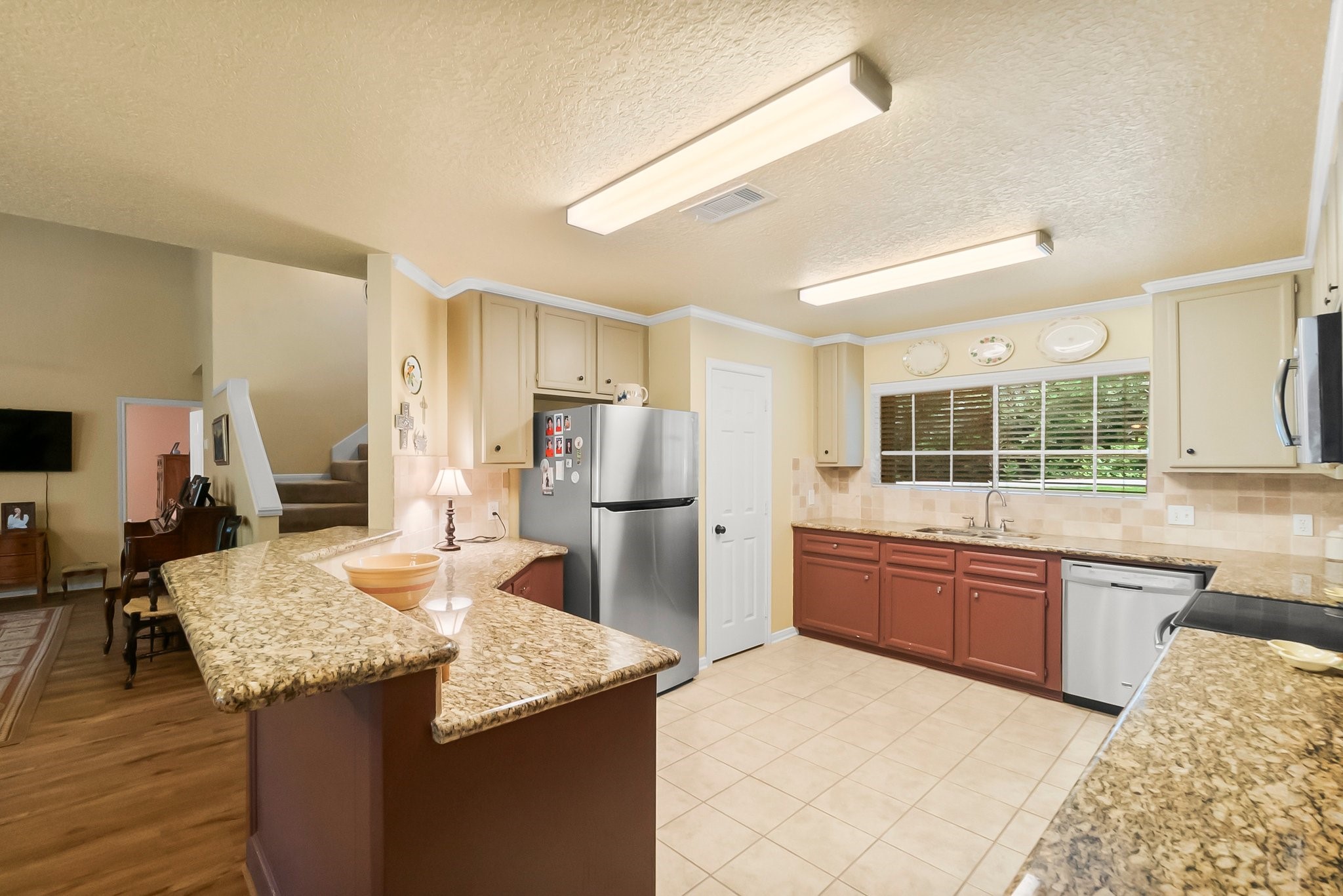 292 Apple Valley Drive Conroe, TX 77304 - Photo 11 of 40 a kitchen with stainless steel appliances granite countertop a sink stove and refrigerator