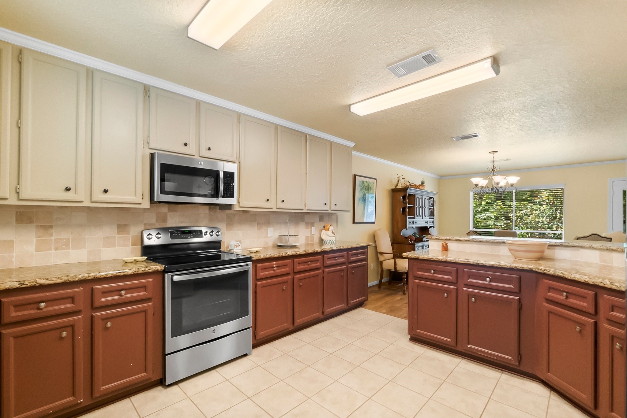 292 Apple Valley Drive Conroe, TX 77304 - Photo 14 of 40 a kitchen with stainless steel appliances granite countertop a sink and cabinets