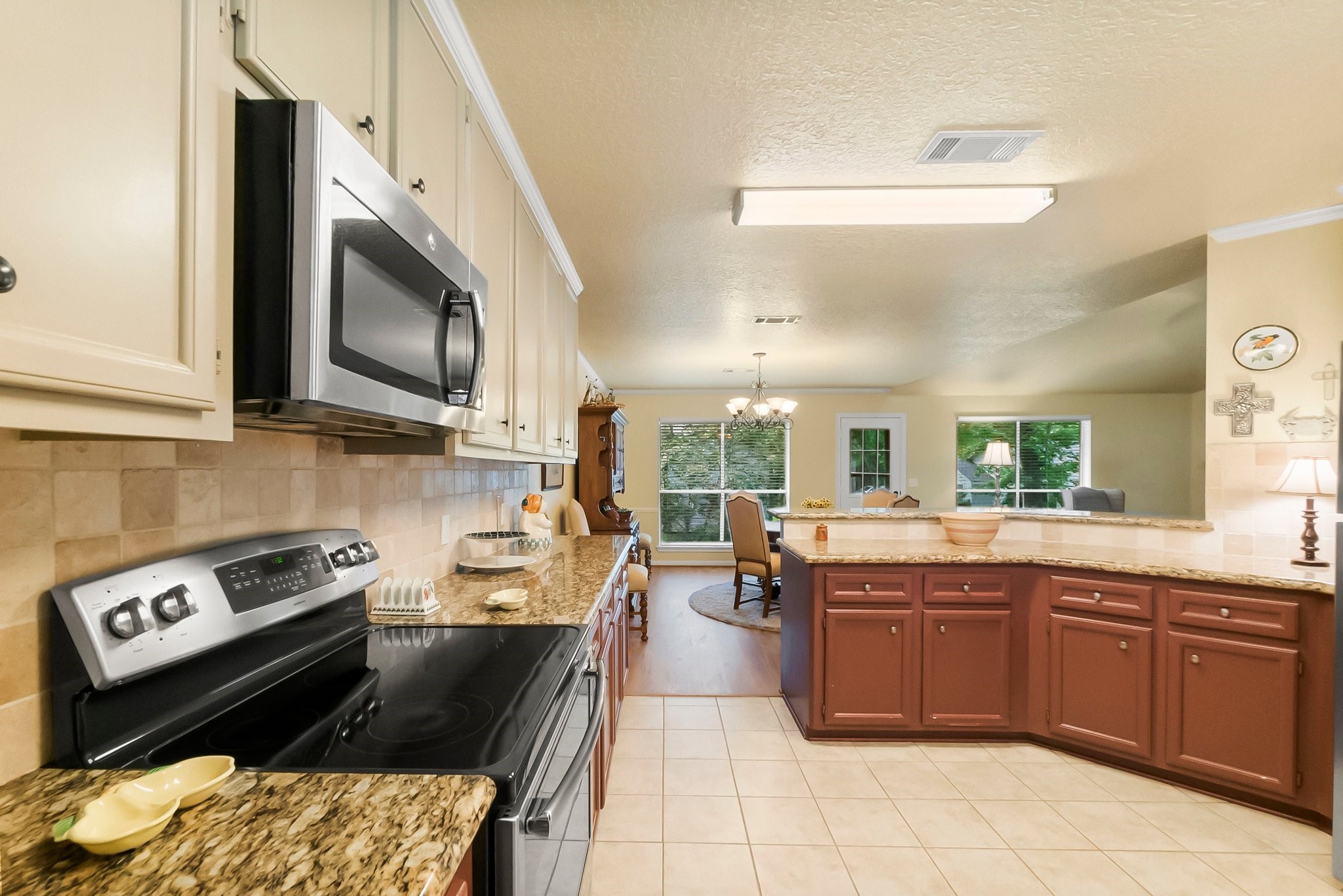 292 Apple Valley Drive Conroe, TX 77304 - Photo 15 of 40 a kitchen with stainless steel appliances granite countertop a stove a sink and a microwave