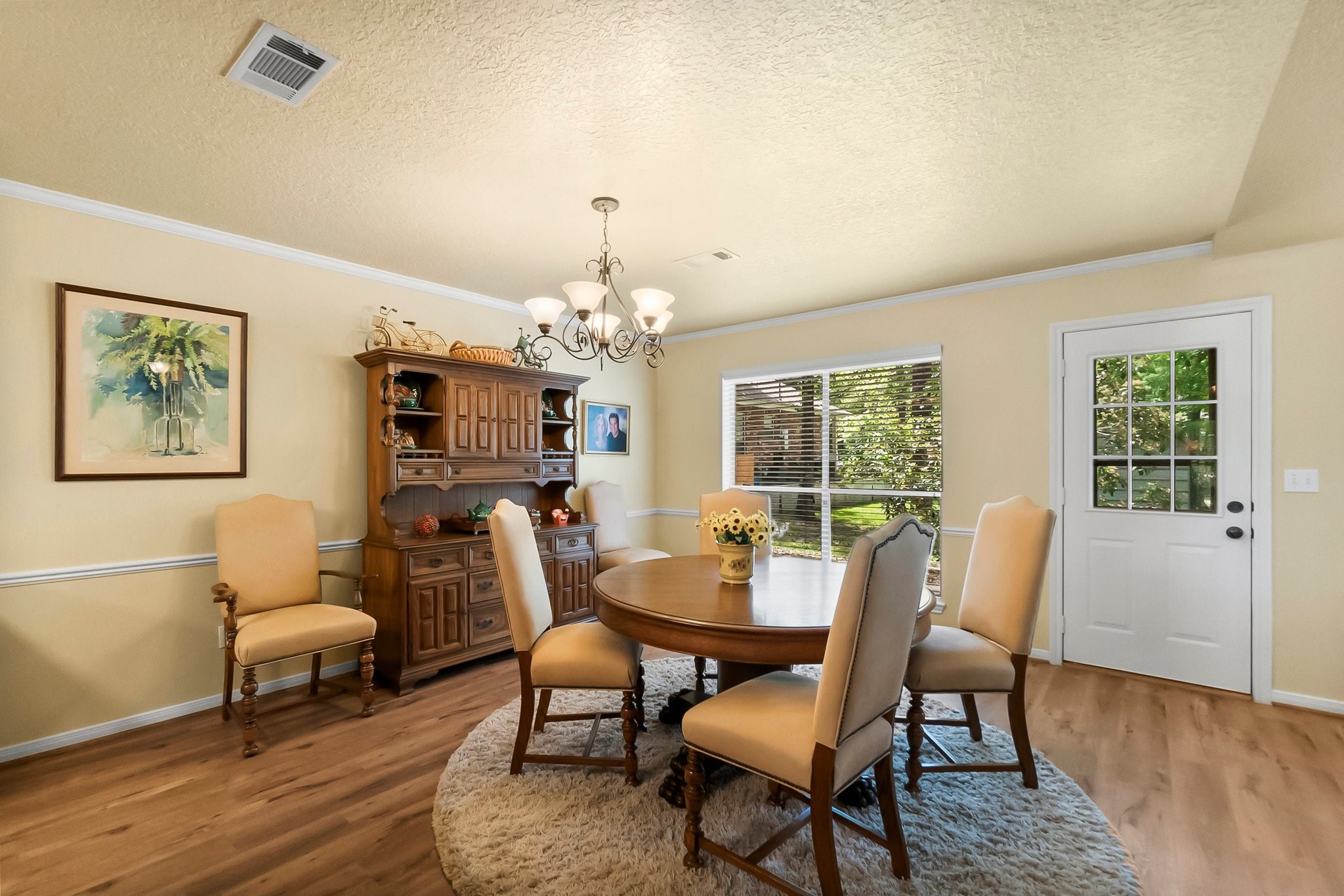 292 Apple Valley Drive Conroe, TX 77304 - Photo 17 of 40 a view of a dining room with furniture a chandelier and wooden floor