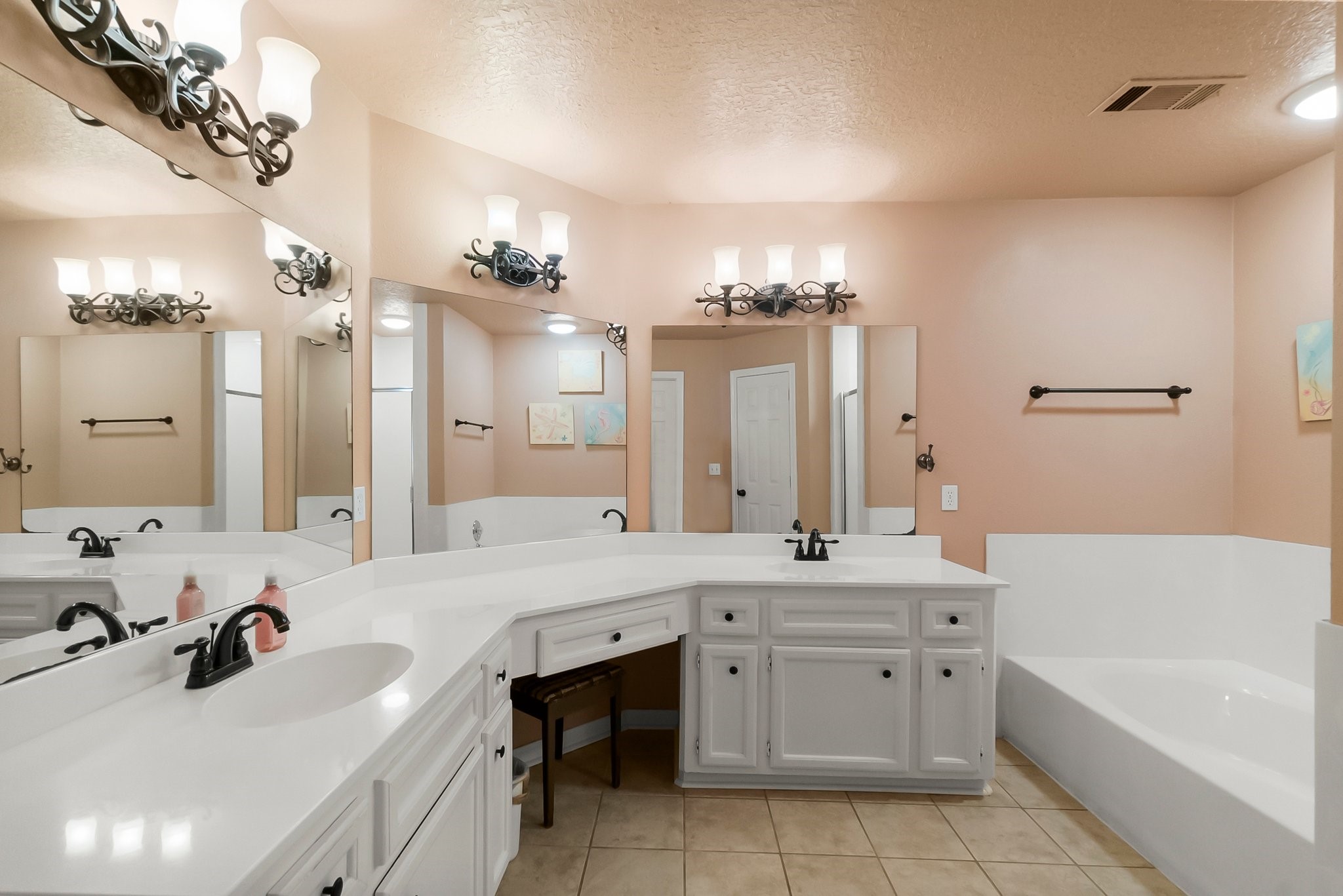 292 Apple Valley Drive Conroe, TX 77304 - Photo 24 of 40 a bathroom with a tub a double vanity sink and mirror
