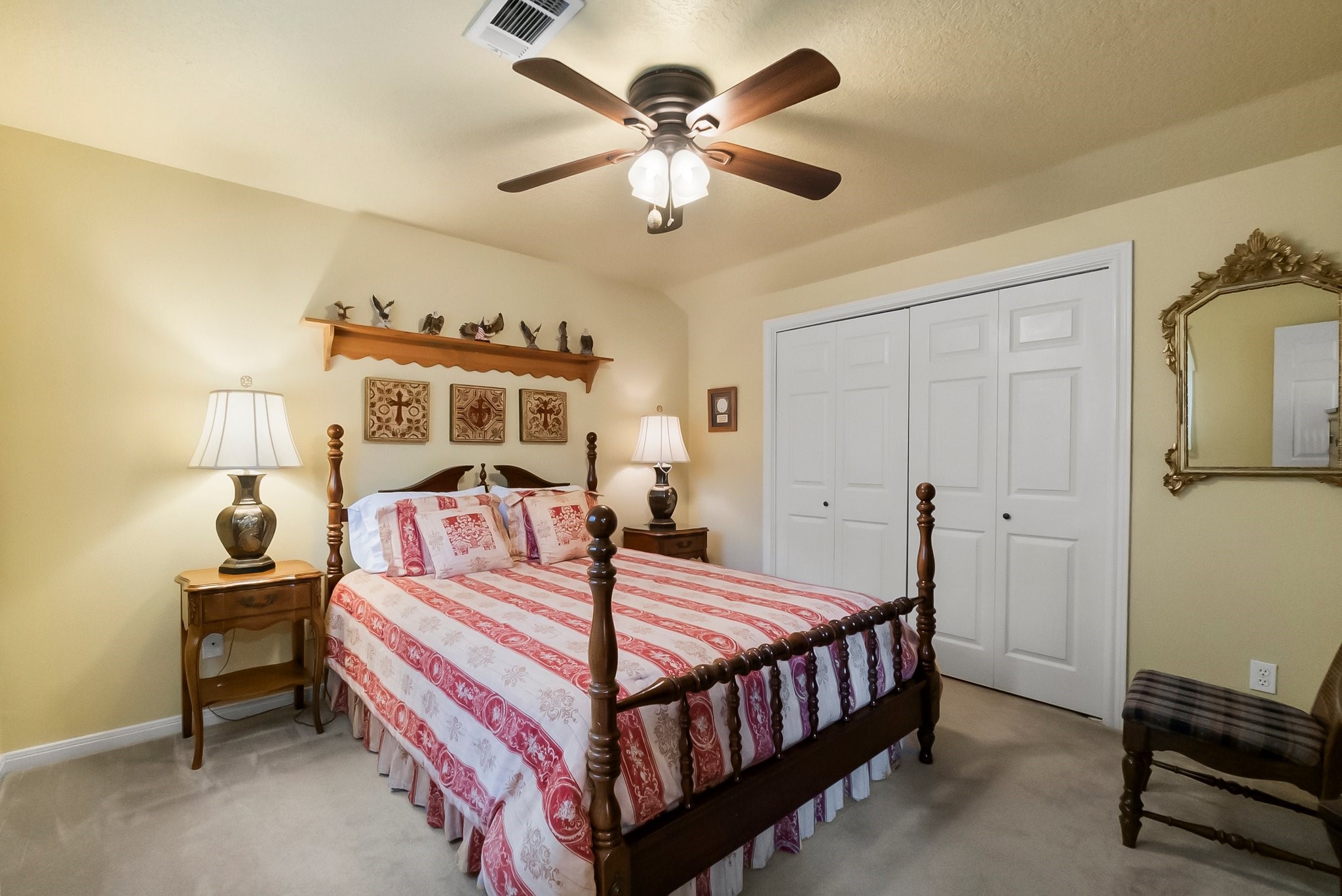 292 Apple Valley Drive Conroe, TX 77304 - Photo 27 of 40 a bedroom with a bed and a chandelier