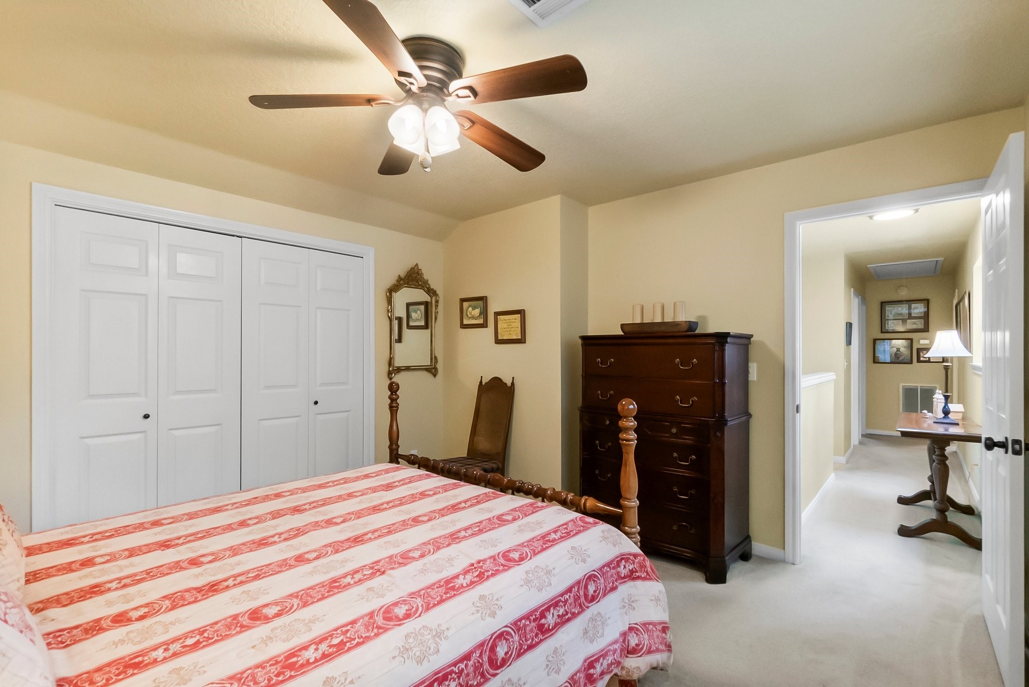 292 Apple Valley Drive Conroe, TX 77304 - Photo 28 of 40 a bedroom with a bed and a chandelier