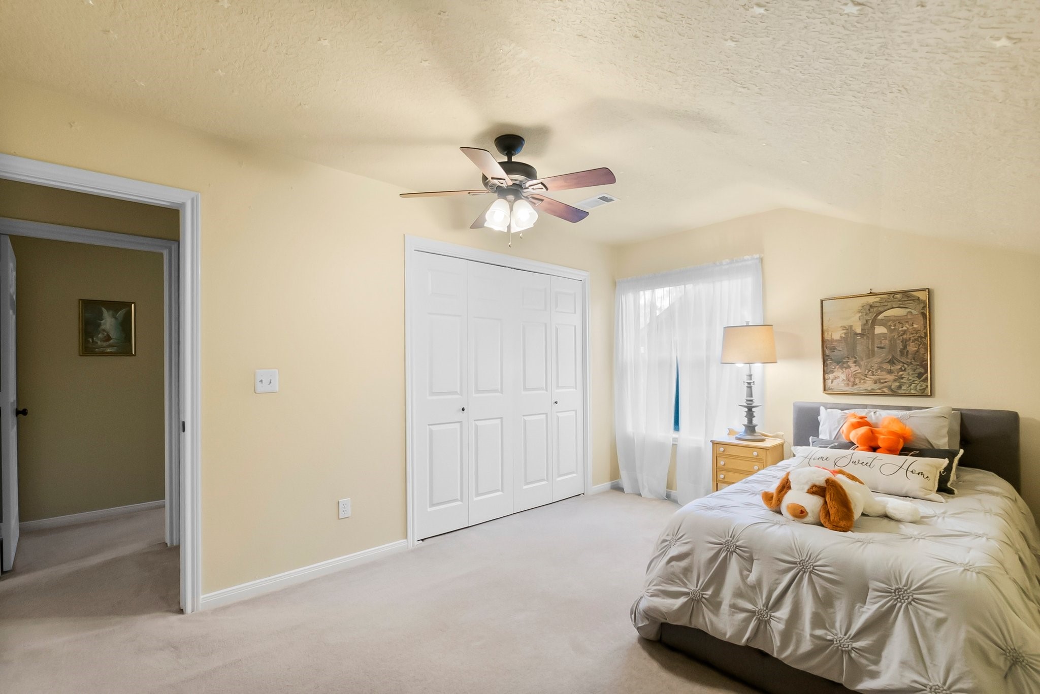 292 Apple Valley Drive Conroe, TX 77304 - Photo 32 of 40 a bedroom with a bed and a chandelier