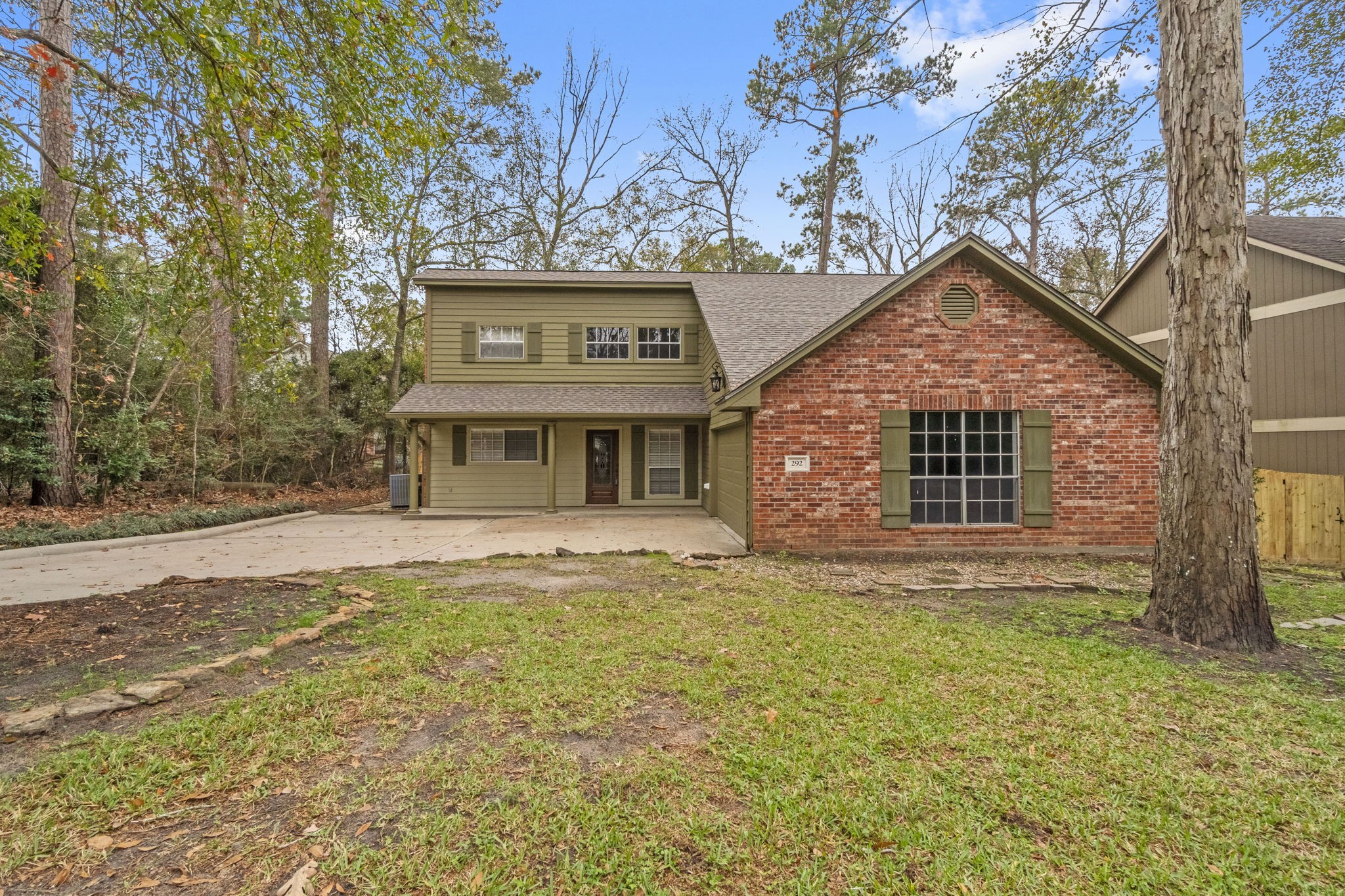 292 Apple Valley Drive Conroe, TX 77304 - Photo 40 of 40 a view of a house with a large tree and a yard