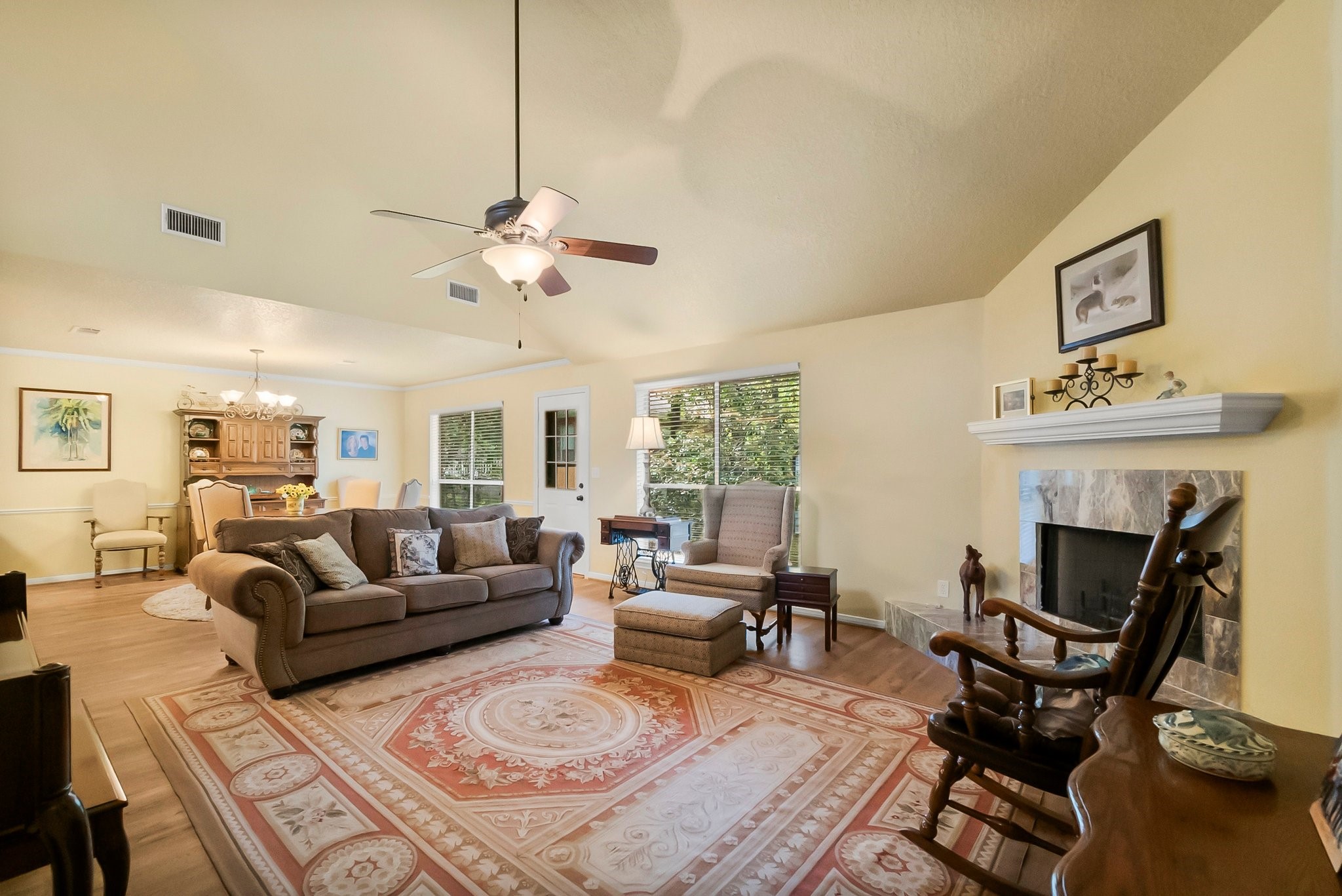 292 Apple Valley Drive Conroe, TX 77304 - Photo 10 of 40 a living room with furniture a fireplace and a chandelier
