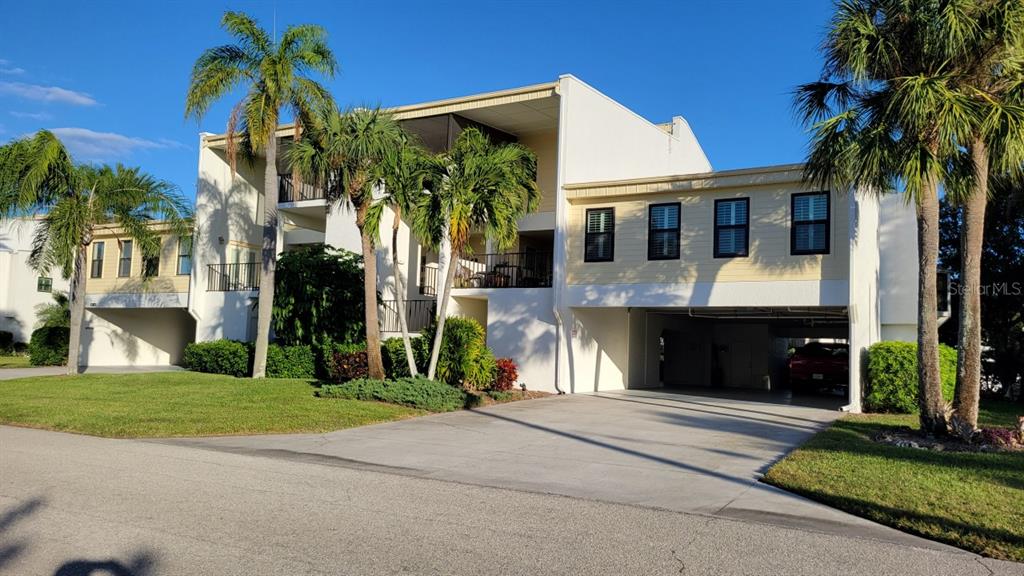 4121 129th Street West, Unit 1 Cortez, FL 34215 - Photo 1 of 32 a front view of a house with a yard and garage