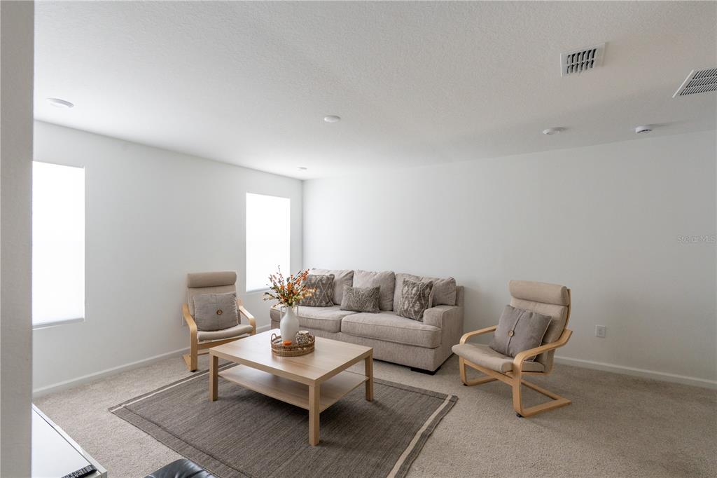 2069 Valencia Blossom Street Clermont, FL 34711 - Photo 12 of 24 a living room with furniture and a window