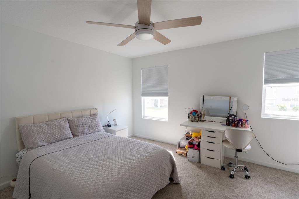 2069 Valencia Blossom Street Clermont, FL 34711 - Photo 13 of 24 a bedroom with a bed and a window