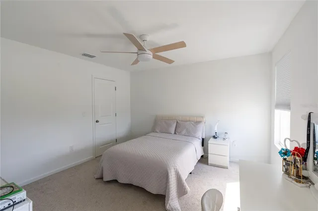a bedroom with a bed and a table