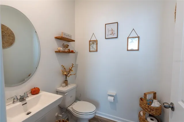 a white toilet sitting next to a bathroom sink and vanity