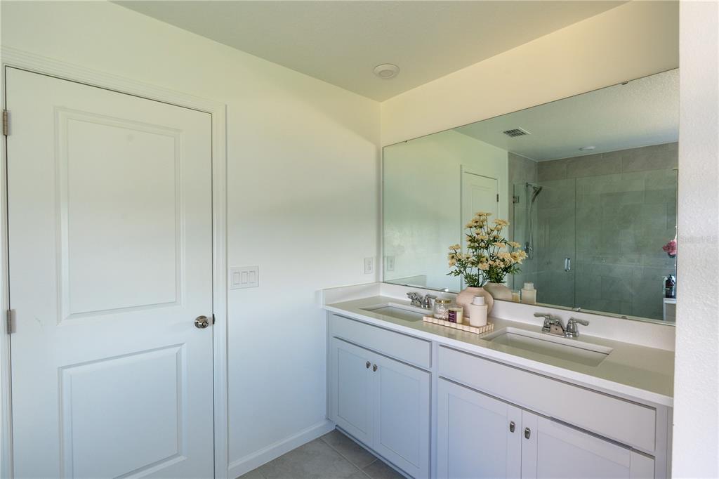 2069 Valencia Blossom Street Clermont, FL 34711 - Photo 19 of 24 a bathroom with a granite countertop sink and a mirror