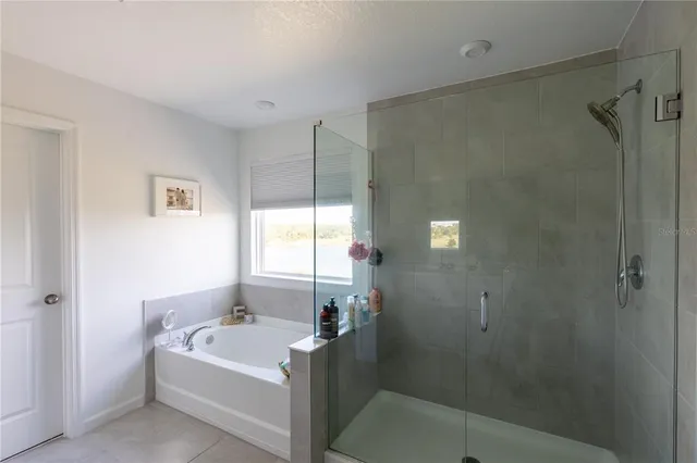 a bathroom with a bathtub and shower
