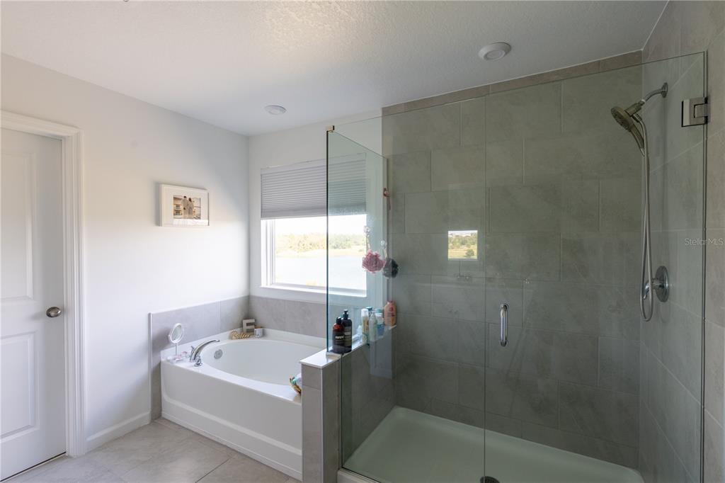 2069 Valencia Blossom Street Clermont, FL 34711 - Photo 22 of 24 a bathroom with a bathtub and shower