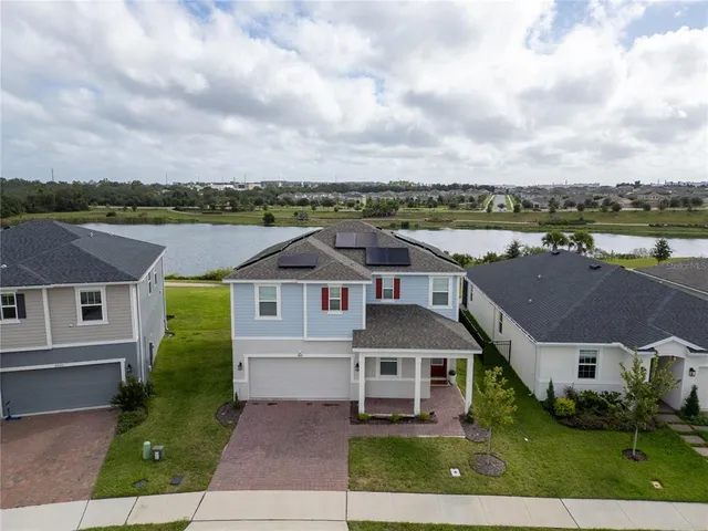 an aerial view of a house with a yard