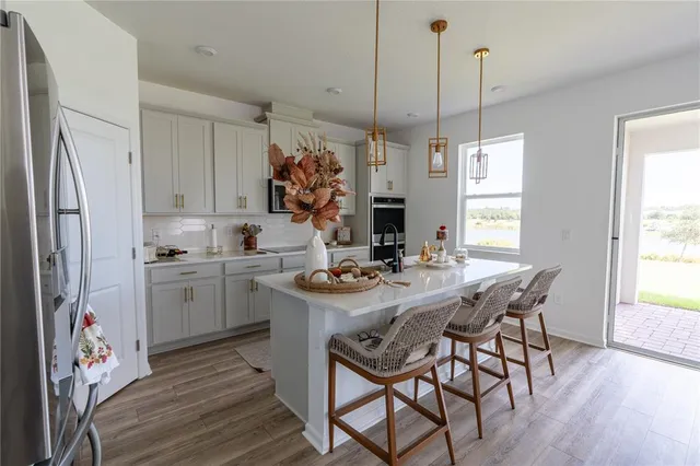 a view of kitchen with sink and refrigerator