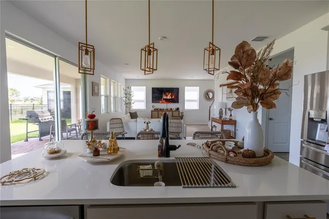 a view of a livingroom with furniture and floor to ceiling window