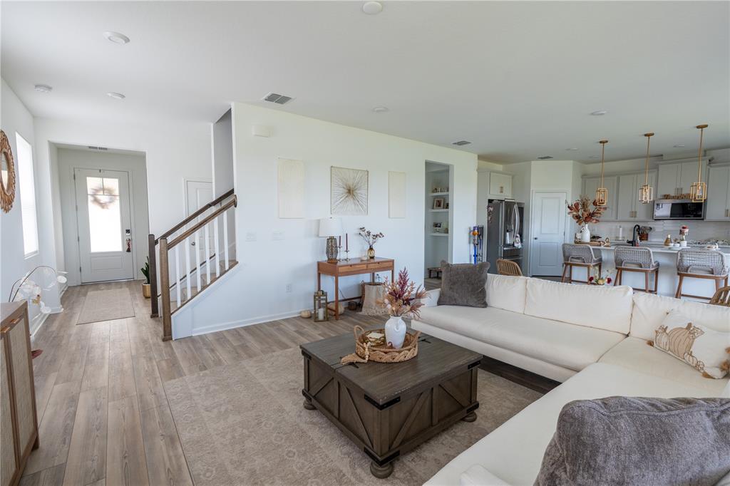 2069 Valencia Blossom Street Clermont, FL 34711 - Photo 6 of 24 a living room with furniture and a wooden floor