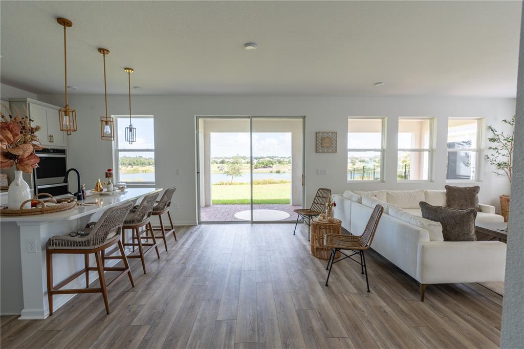2069 Valencia Blossom Street Clermont, FL 34711 - Photo 7 of 24 a living room with furniture a flat screen tv and a large window