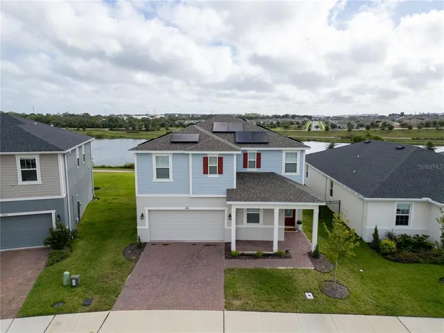 an aerial view of a house with a yard