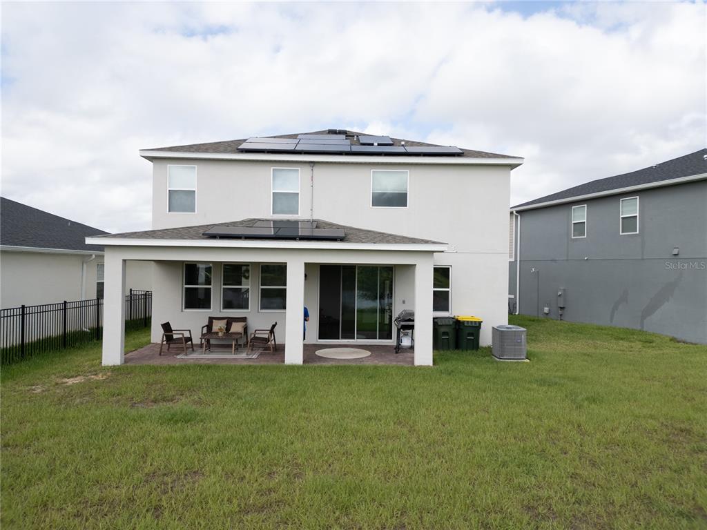 2069 Valencia Blossom Street Clermont, FL 34711 - Photo 9 of 24 a view of a house with a yard and sitting area