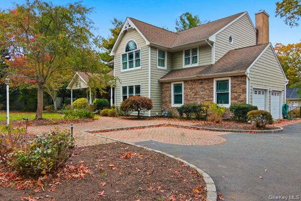 a front view of a house with yard and green space