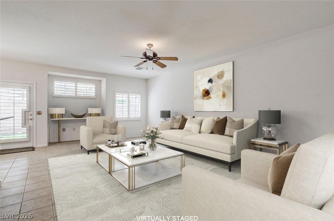 1479 Orange Jubilee Road Henderson, NV 89014 - Photo 1 of 36 Natural light illuminates this spacious living area with durable tile flooring and a ceiling fan for comfort.