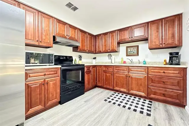 a bathroom with a sink a mirror and potted plant