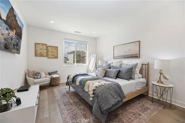 a bedroom with bed and a couch