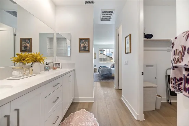 a en suite bathroom with a granite countertop sink and a mirror