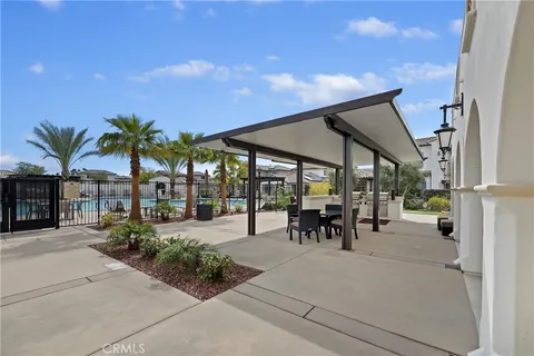 a view of a patio with swimming pool and a chairs