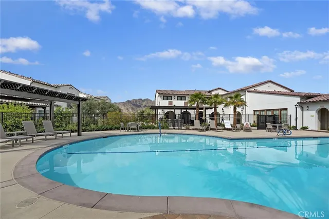 a front view of a house with swimming pool yard and outdoor seating