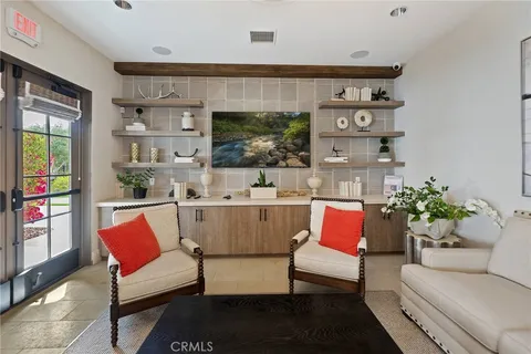 a kitchen island with stainless steel appliances a table and chairs in it