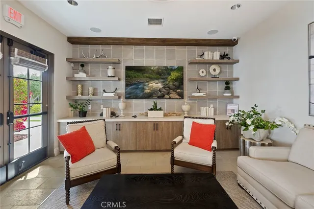 a kitchen island with stainless steel appliances a table and chairs in it