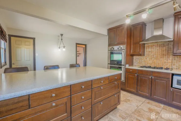 a spacious bathroom with a granite countertop sink and a mirror