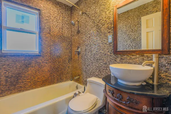 a bathroom with a toilet a sink and a bathtub