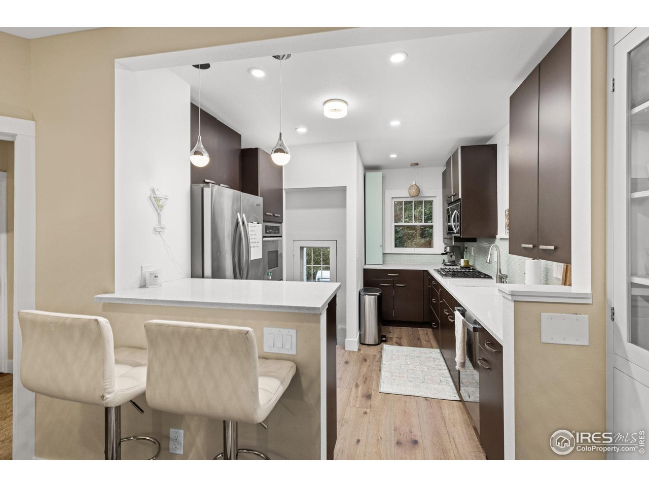 830 15th Street Boulder, CO 80302 - Photo 11 of 40 a kitchen with a table chairs refrigerator and microwave