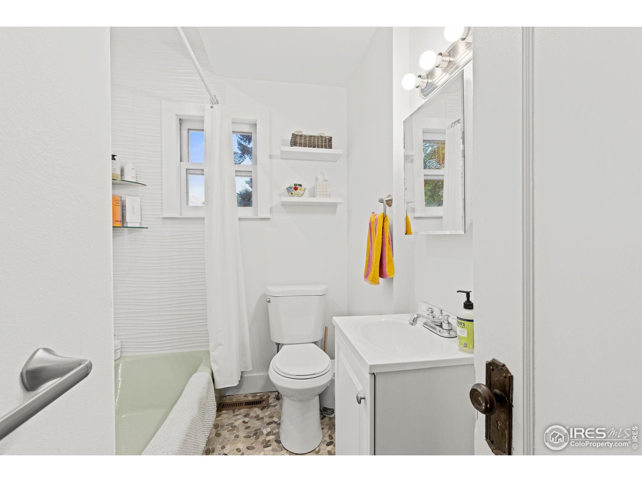830 15th Street Boulder, CO 80302 - Photo 15 of 40 a bathroom with a toilet sink and mirror