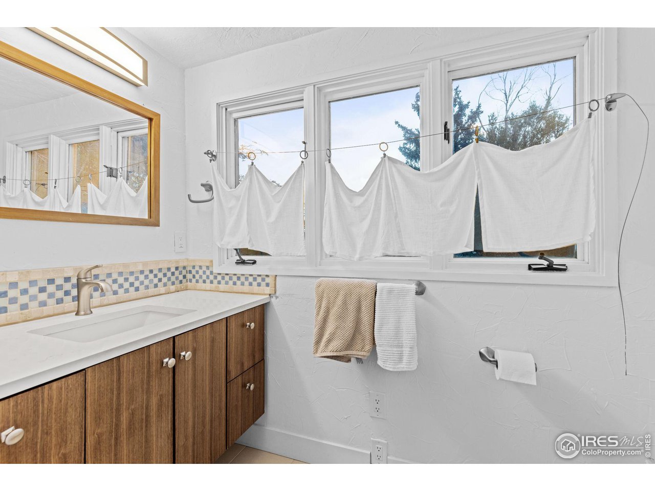 830 15th Street Boulder, CO 80302 - Photo 20 of 40 a bathroom with a sink vanity and mirror