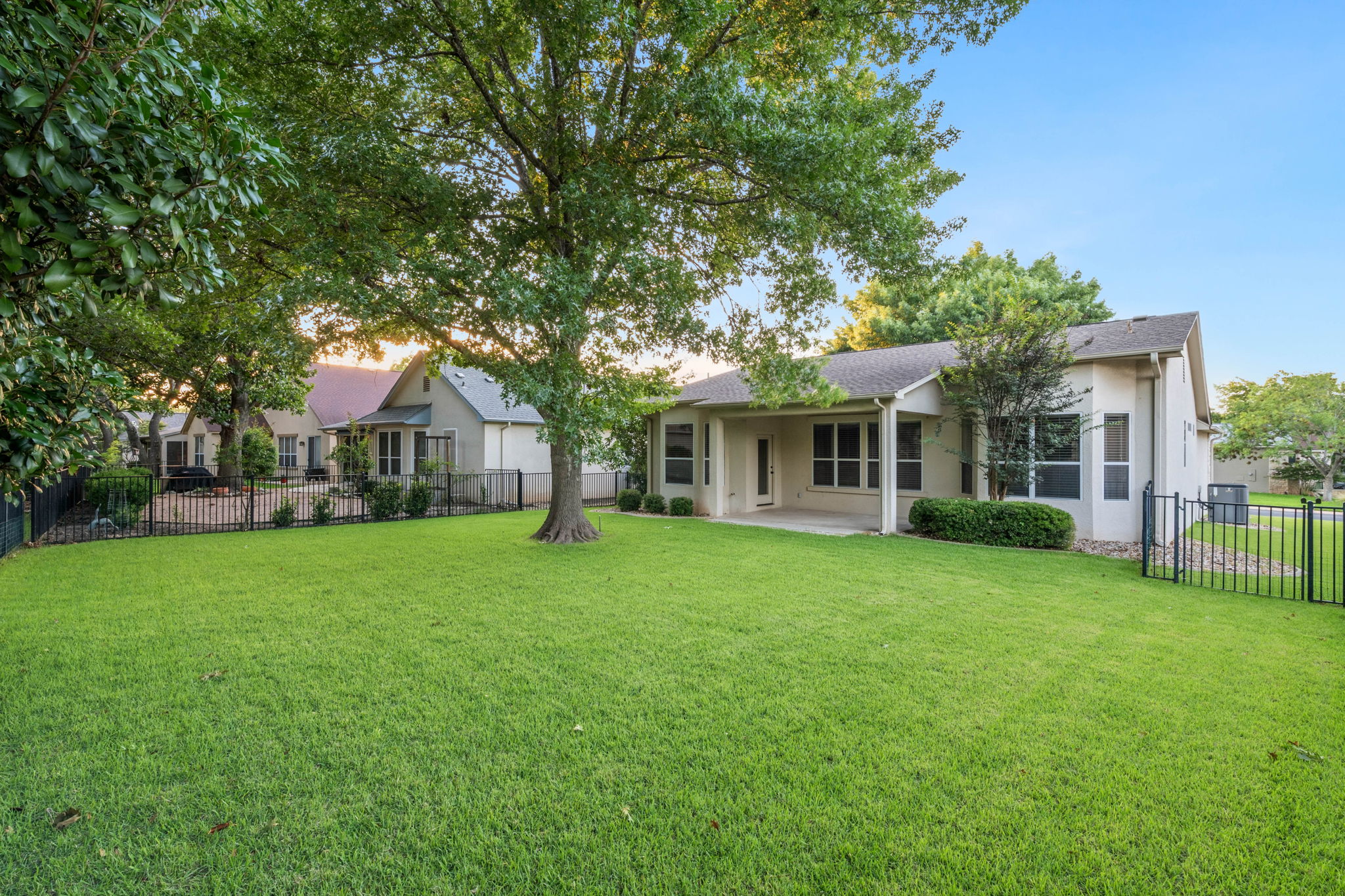 137 Trail Rider Way Georgetown, TX 78633 - Photo 23 of 29 A fenced backyard offers a lush lawn and covered patio for outdoor enjoyment.