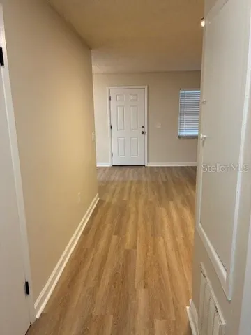 a view of a room with wooden floor and bench