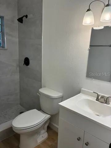 a bathroom with a toilet a sink and shower