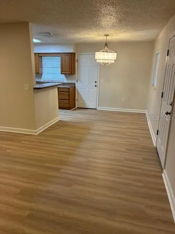 a view of a kitchen with a sink and wooden floor