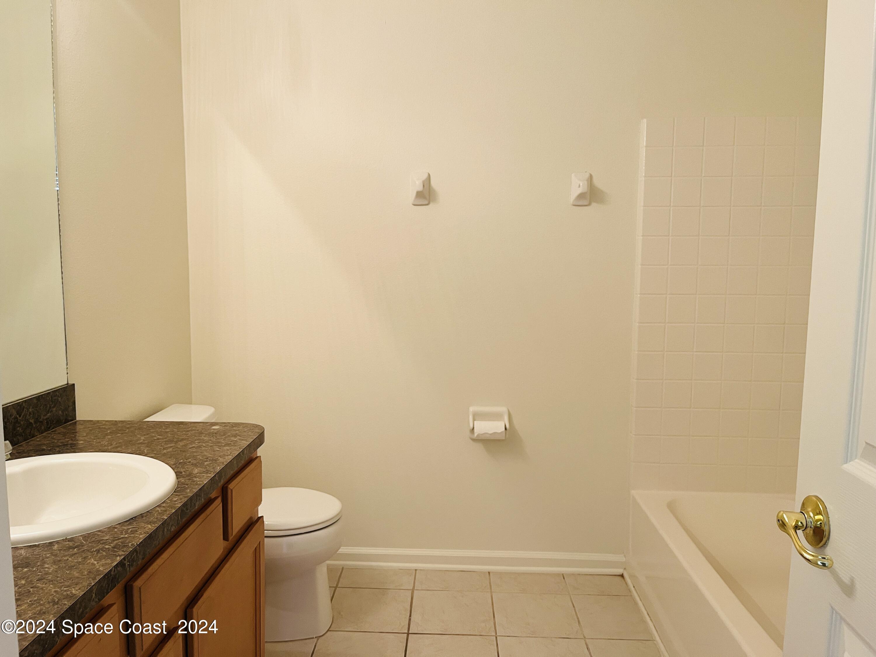 4006 Meander Place, Unit 201 Rockledge, FL 32955 - Photo 12 of 20 a bathroom with a granite countertop sink and a mirror