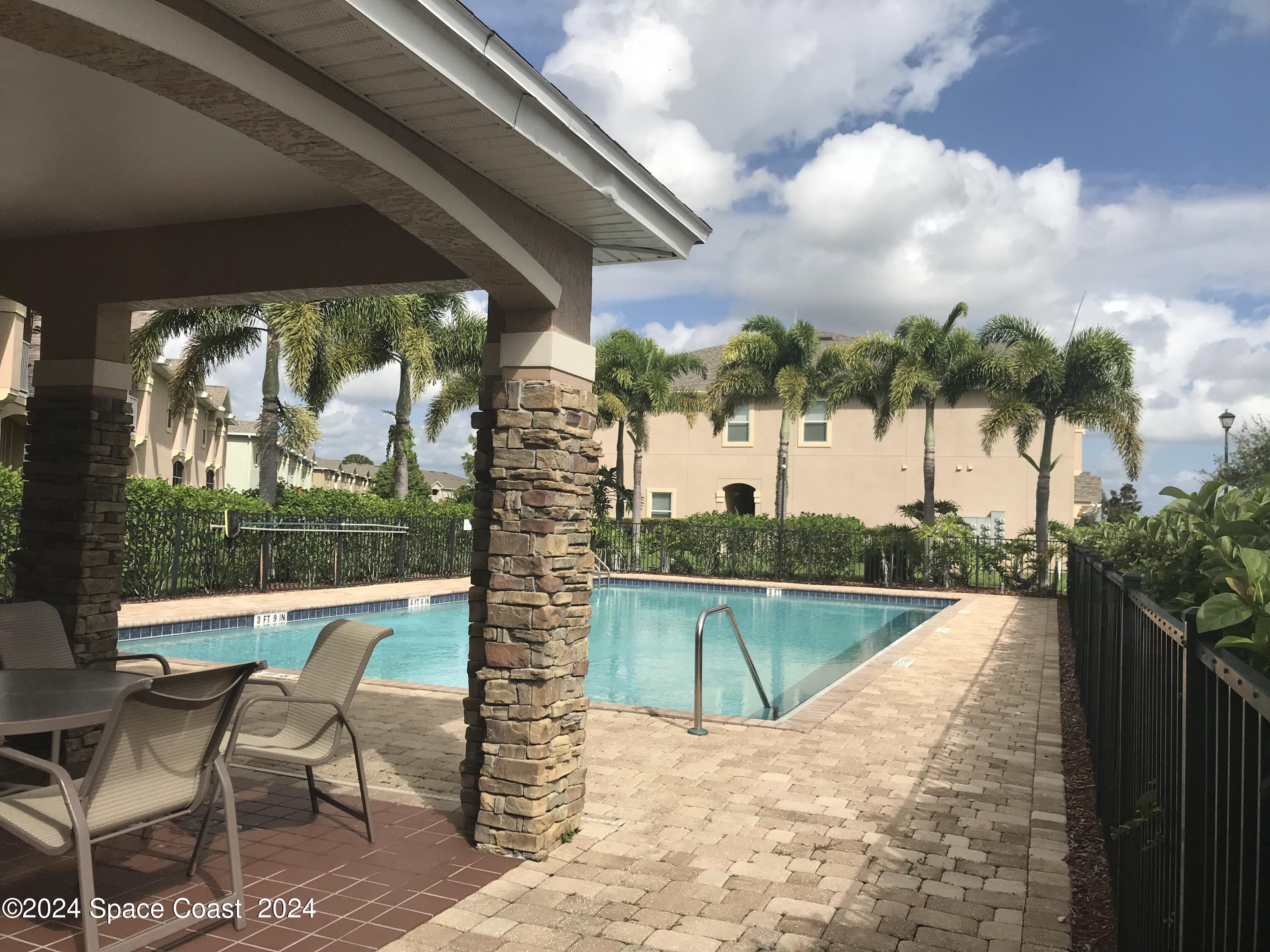 4006 Meander Place, Unit 201 Rockledge, FL 32955 - Photo 18 of 20 a view of a swimming pool with a patio