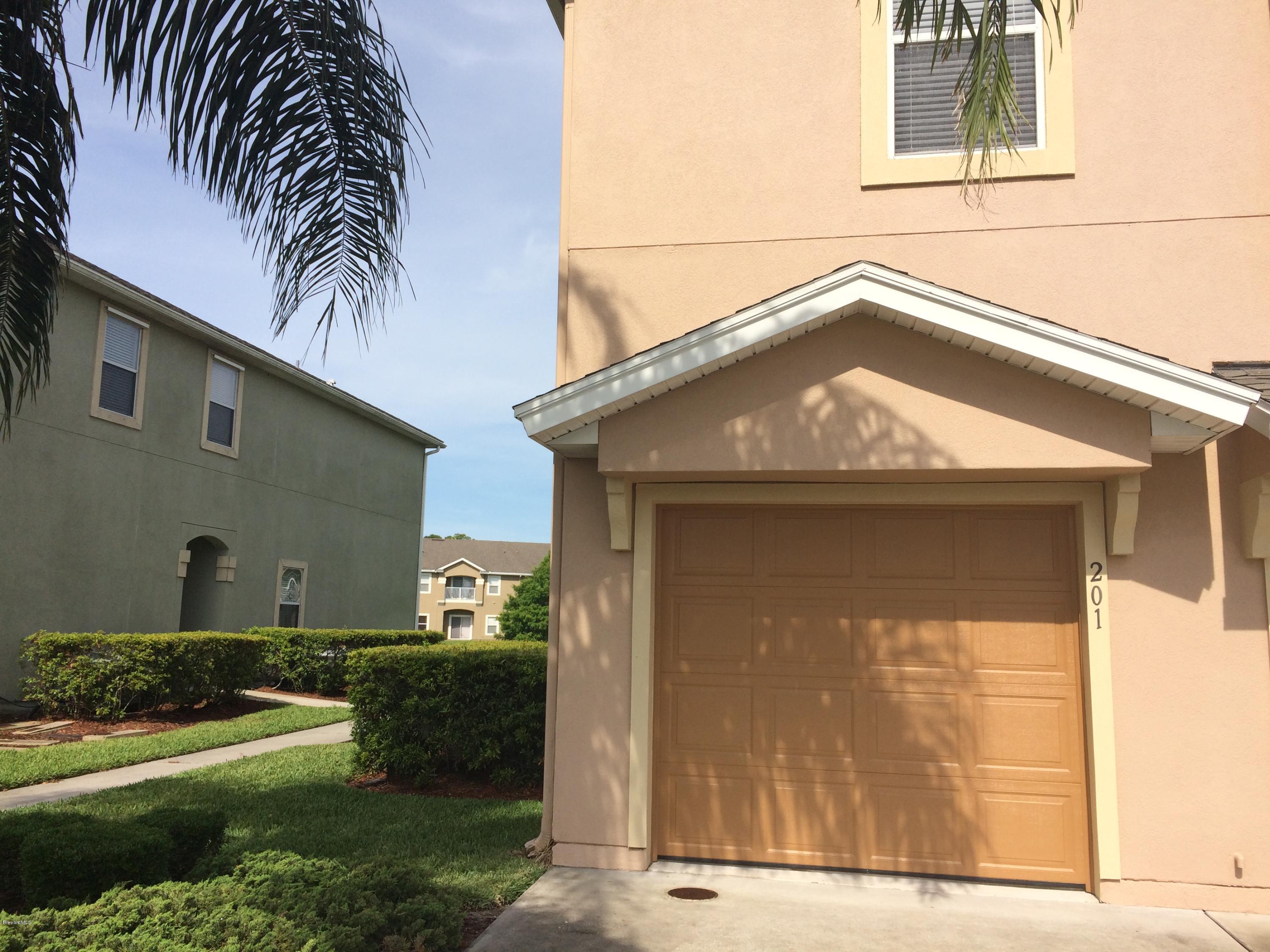 4006 Meander Place, Unit 201 Rockledge, FL 32955 - Photo 2 of 20 a front view of a house with a yard
