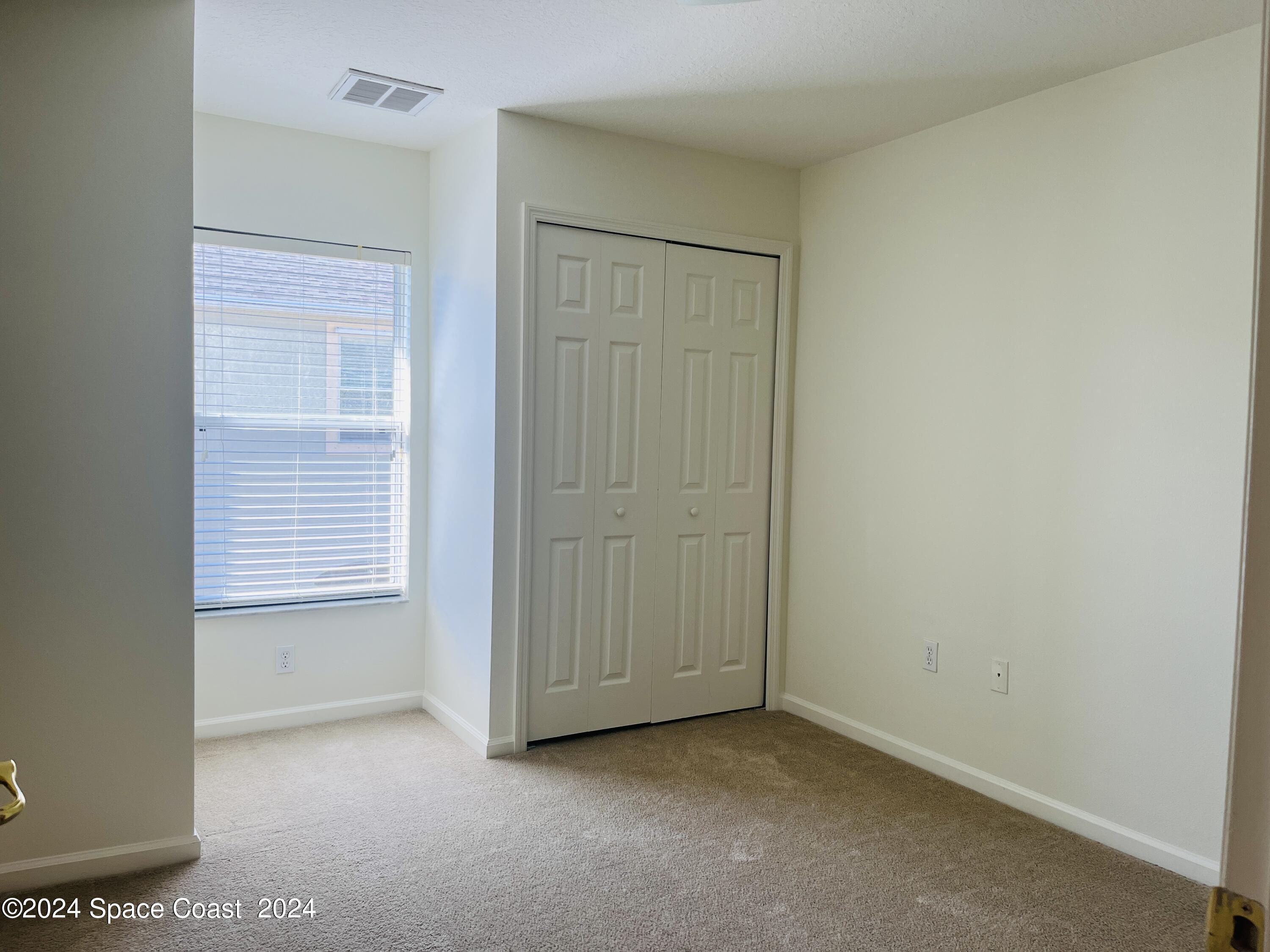 4006 Meander Place, Unit 201 Rockledge, FL 32955 - Photo 10 of 20 a view of an empty room with closet and mirror