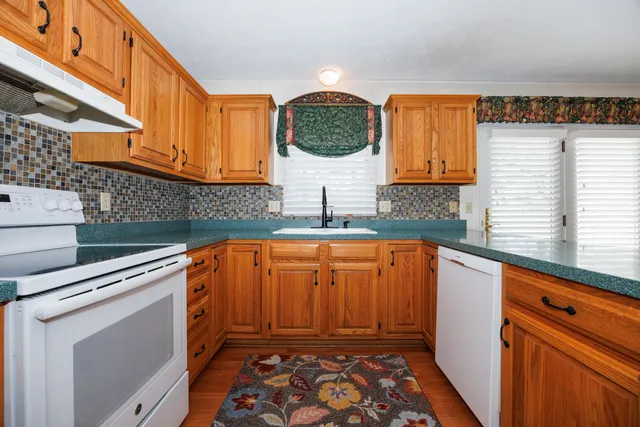 a kitchen with stainless steel appliances a stove a sink and a microwave
