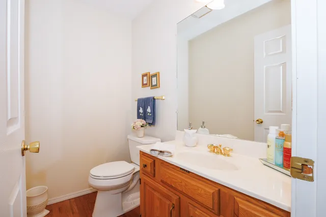 a bathroom with a sink vanity mirror and toilet