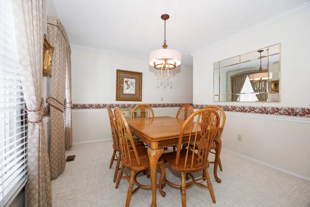 a view of a dining room with furniture and chandelier